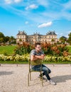 Young men visiting Le Jardin Luxembourg park in Paris during summer in the city of Paris France