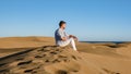 Young men walking at the beach of Maspalomas Gran Canaria Spain, men at the sand dunes desert Royalty Free Stock Photo