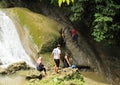 Young men in waterfall