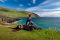 Young man and woman thoughtfully look at the sea landscape of Coumeenoole beach at the Atlantic coast of Ireland Royalty Free Stock Photo