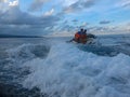 Young man and woman drifting across the sea surface. People on Jet Ski have fun in Ocean. Driver in action during splashing water.