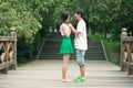 Young men and women face to face on the bridge Royalty Free Stock Photo