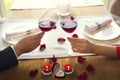 Young couple having romantic dinner in the restaurant drinking wine cheers close-up