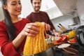 Young couple having romantic evening at home in the kitchen cooking meal together close-up Royalty Free Stock Photo