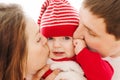 Parents kissing baby in cheeks Royalty Free Stock Photo
