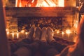 Young couple near the fireplace at home winter legs close-up Royalty Free Stock Photo