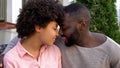 Young man and woman nuzzling, romantic date in cafe garden, tender relations Royalty Free Stock Photo