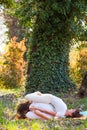 Young man and woman practice partner yoga outdoor in wood summer day