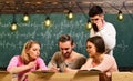 Young men and women sitting in college. Students using technology to learn the lessons of the student group during Royalty Free Stock Photo