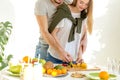 Young man and woman wcutting ingredients very carefully Royalty Free Stock Photo