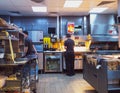 young men works in kitchen of fastfood restaurant