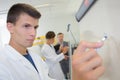 Young man writing on whiteboard Royalty Free Stock Photo