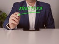 Young Merchant writing EQUITIES with marker in the office Royalty Free Stock Photo