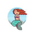 Young mermaid sits on the rocks against the background of the sea.