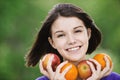 Young merry woman holding fruits Royalty Free Stock Photo