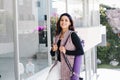 Young mexican business woman or student practicing breathing yoga exercises at workplace, office meditation holding a cellphone on Royalty Free Stock Photo