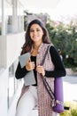 Young mexican business woman or student practicing breathing yoga exercises at workplace, office meditation holding a cellphone on Royalty Free Stock Photo