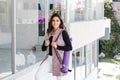 Young mexican business woman or student practicing breathing yoga exercises at workplace, office meditation holding a cellphone on Royalty Free Stock Photo