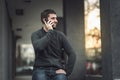 Handsome young man talking on his phone in an urban area Royalty Free Stock Photo