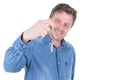 Young middle aged man hand over keys with empty white background Royalty Free Stock Photo