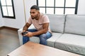 Young middle east man playing video game at home Royalty Free Stock Photo