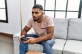 Young middle east man playing video game at home Royalty Free Stock Photo