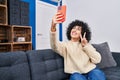 Young middle east woman doing victory gesture make selfie by smartphone at home Royalty Free Stock Photo