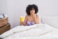 Young middle east woman drinking cup of coffee sitting on bed at bedroom Royalty Free Stock Photo