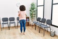 Young middle east woman holding clipboard looking watch at waiting room Royalty Free Stock Photo