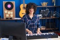 Young middle east woman musician playing piano keyboard at music studio Royalty Free Stock Photo