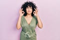 Young middle east woman wearing casual clothes relax and smiling with eyes closed doing meditation gesture with fingers