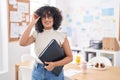 Young middle eastern woman business worker smiling confident holding binder at office Royalty Free Stock Photo