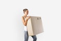 Young miillennial woman relocation with huge carton box. Online purchase, delivery person.