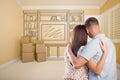 Young Military Couple In Empty Room with Shelf Drawing on Wall Royalty Free Stock Photo