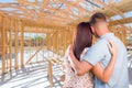 Young Military Couple On Site Inside Their New Home Construction