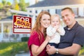 Young Military Family in Front of Sold Sign and House Royalty Free Stock Photo