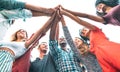 Young millenial friends stacking hand on high five move - Multiracial culture and unity with students having fun together