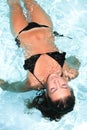 Millennial girl float at pool during summer Royalty Free Stock Photo