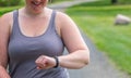 Young millennial mom tracking fitness on smart watch