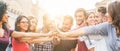 Young millennials friends stacking hands together - Happy students celebrating together - Youth lifestyle, university, Royalty Free Stock Photo