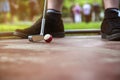 Young minigolf player tries to put a small looking billard cue b