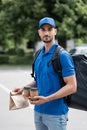 Young mislim courier with thermo backpack