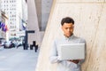 Young Mix-Race American Man working on laptop computer outside office in New York City Royalty Free Stock Photo