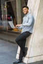 Young Mix-Race American Man working on laptop computer outside office in New York City Royalty Free Stock Photo