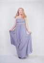 Young mix race happy adult woman in a grey long shiffon evening wear