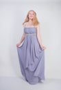 Young mix race happy adult woman in a grey long shiffon evening wear