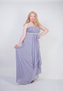 Young mix race happy adult woman in a grey long shiffon evening wear