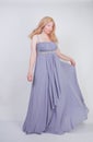 Young mix race happy adult woman in a grey long shiffon evening wear