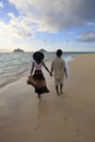 Young mixed couple walk on a beach