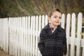 Young Mixed Race Boy Waiting For School Bus Along Fence Outside Royalty Free Stock Photo